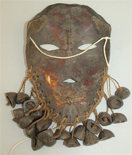 A tribal carved bone mask, 8.5in.